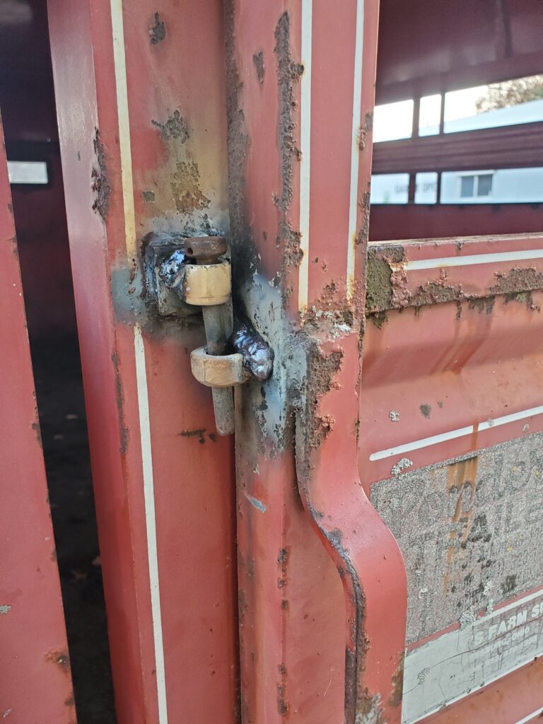 Welded nuts to edge of sliding door to accept locking pin .